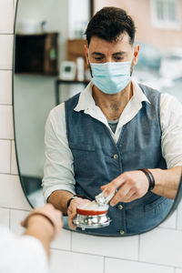 Full length portrait of young man standing outdoors