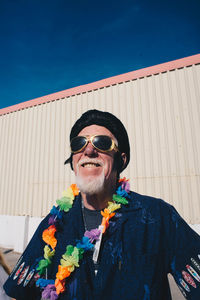 Portrait of man wearing sunglasses standing against sky