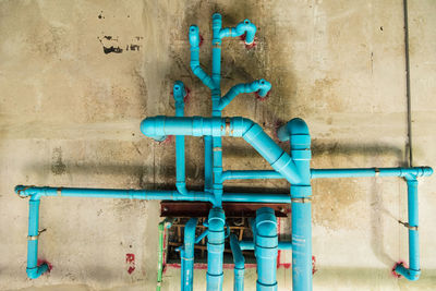 Blue pipes against wall