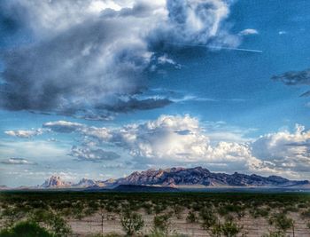 Scenic view of mountains against cloudy sky