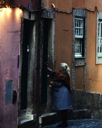 Rear view of man working on building