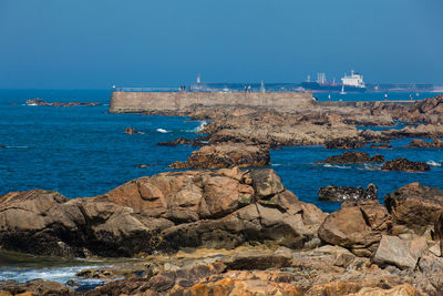 Scenic view of sea against clear blue sky