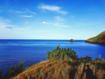 Scenic view of sea against blue sky