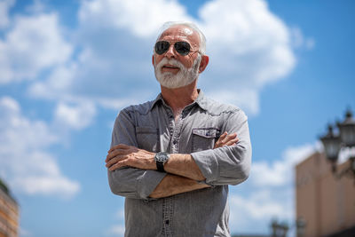 Portrait of man standing against sky