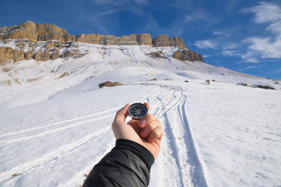 Man holding snow on mountain