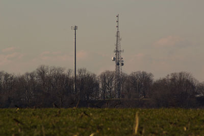 Low angle view of communications tower against sky at sunset