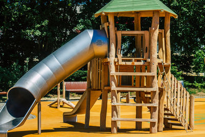 Low angle view of playground against trees in park