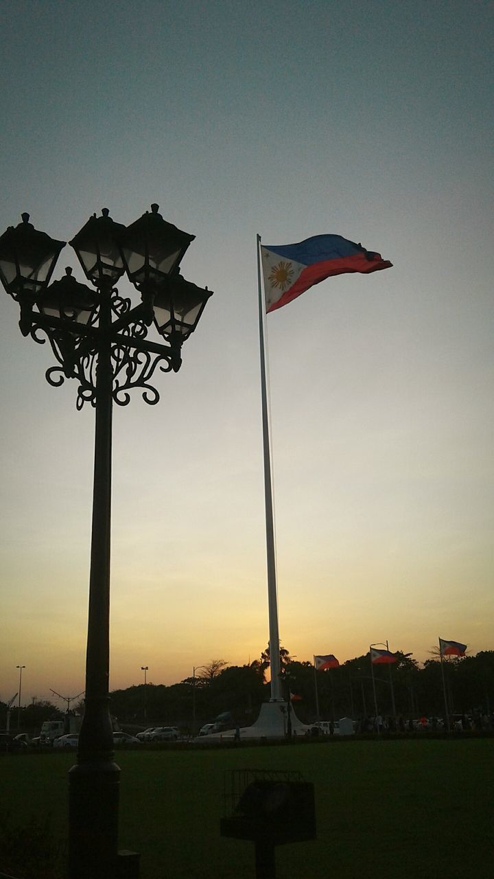 FLAG AGAINST SKY DURING SUNSET