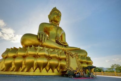 Low angle view of statue against temple