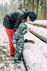 Mother with son on snow covered land
