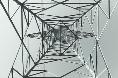 Low angle view of electricity pylon against sky