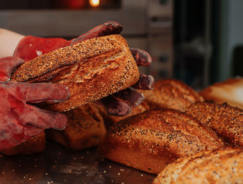 Baker takes out freshly baked bread from the mold