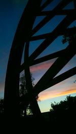 Low angle view of bridge against cloudy sky