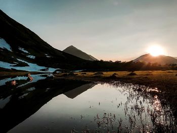 Scenic view of lake against sky during sunset