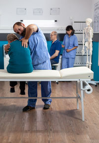 Chiropractor treating patient in clinic