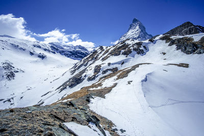 Scenic view of snowcapped mountains against sky