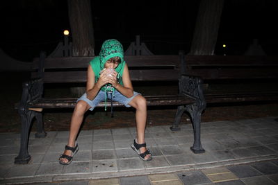 Woman sitting on chair at night