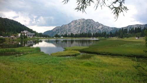 Scenic view of lake and mountains against sky