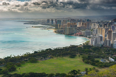 High angle view of sea and buildings against sky