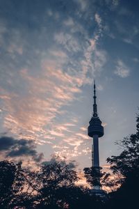 Low angle view of buildings against cloudy sky