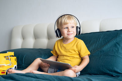 Cute boy watching movie on digital tablet