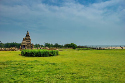 Temple on field against sky