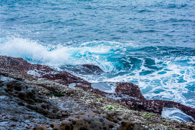 Waves splashing on rocks at shore