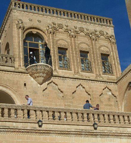 architecture, building exterior, built structure, arch, low angle view, window, history, clear sky, facade, sky, building, men, transportation, day, blue, travel, outdoors, city, art and craft