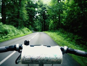 Cropped image of bicycle handle with map