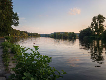 Scenic view of lake against sky at sunset