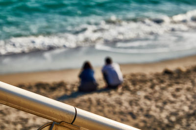 Rear view of people on beach