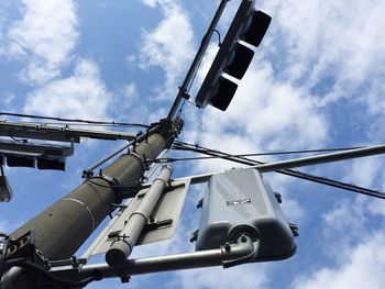 Low angle view of road signals against sky