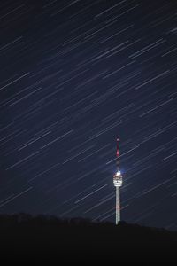 Low angle view of illuminated tower against sky at night