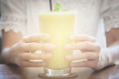 Midsection of woman holding drink