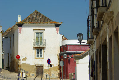 An empty street with deteriorated residential buildings in portuguese town tavira. algarve, portugal