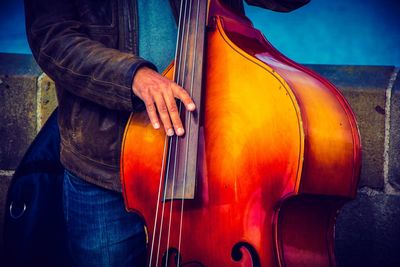 Man playing double bass on street