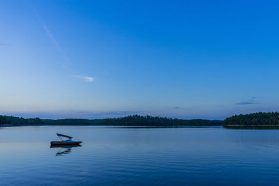 Scenic view of lake against blue sky