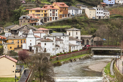 Canal by buildings in town