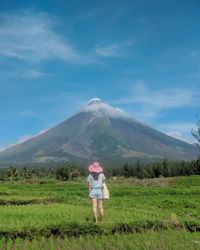Full length of man standing on field against sky