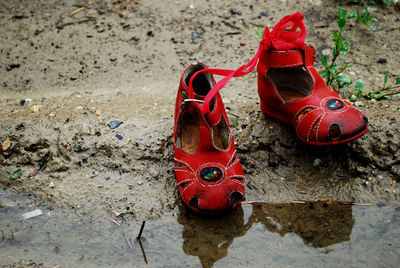 Close-up of shoes on sand