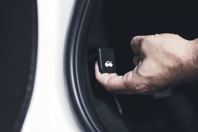 Close-up of man hand in car