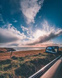 Scenic view of field against sky seen through car windshield