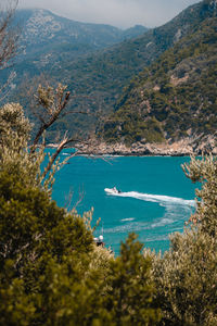 Scenic view of sea and mountains against sky