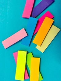 Close-up of colored pencils over blue background