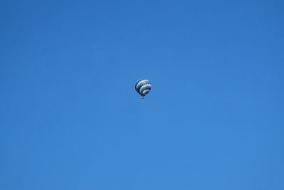 Low angle view of hot air balloon against blue sky