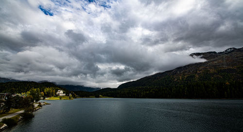 Scenic view of lake by mountain against sky