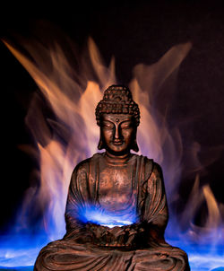 Statue of buddha against blurred background