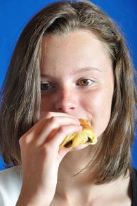 Close-up portrait of a woman eating food