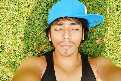 Directly above shot of young man sleeping on field