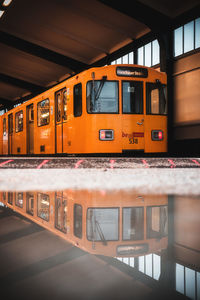 Train at railroad station platform seen through window